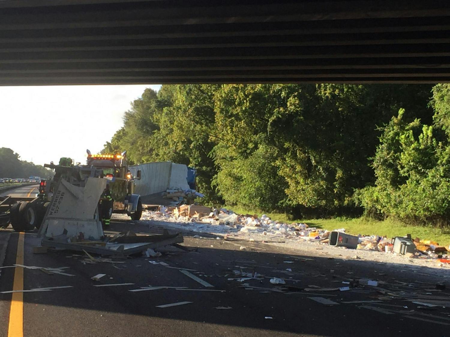 Construction materials spilled over all three Southbound lanes on Interstate 75 after a semi tipped over Friday morning.
