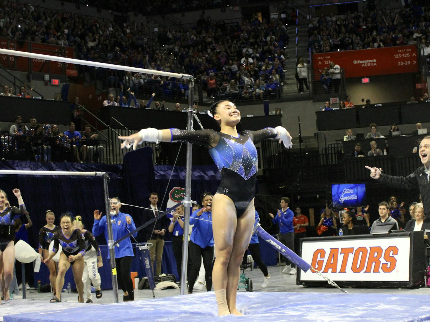 Leanne Wong dismounts after her bar routine against the Auburn Tigers Friday, Jan. 13, 2023.