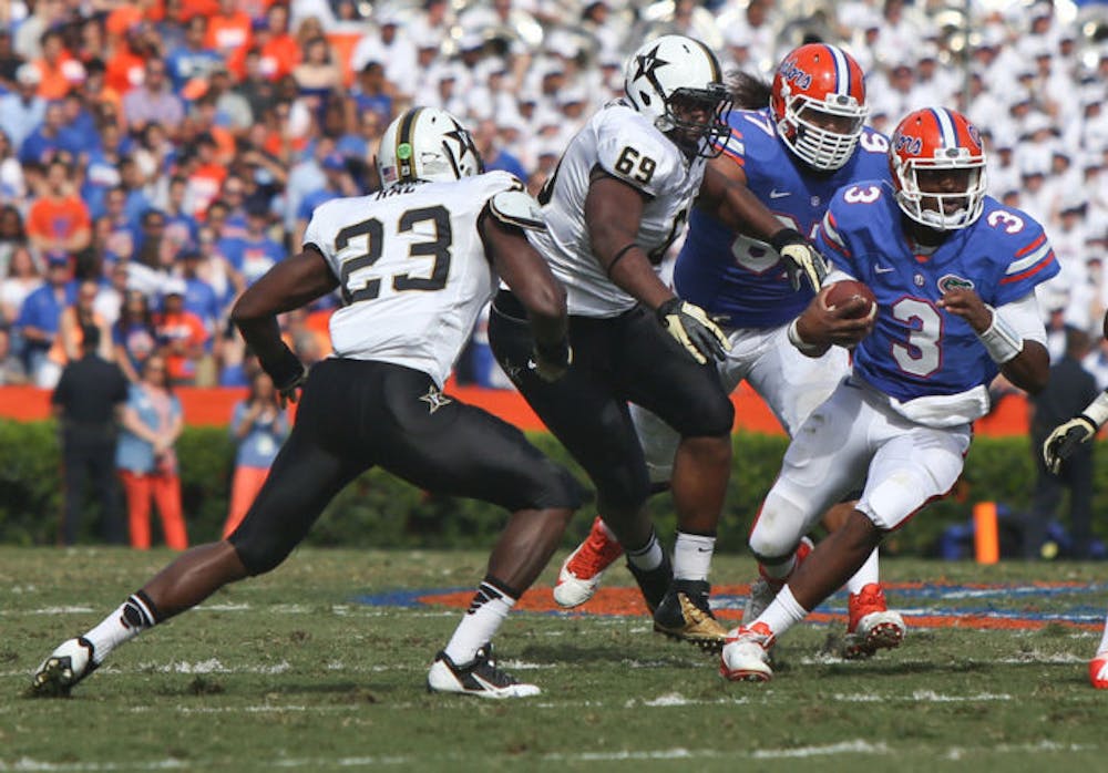 <p>Tyler Murphy (3) attempts to scramble during Florida’s 34-17 loss to Vanderbilt on Saturday in Ben Hill Griffin Stadium. The redshirt junior has a sprained shoulder.</p>
