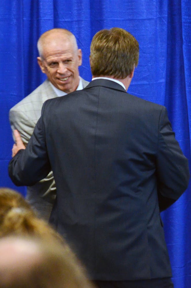 UF athletics director Jeremy Foley and head coach Jim McElwain shake hands during McElwain's opening press conference on Saturday in Ben Hill Griffin Stadium.
