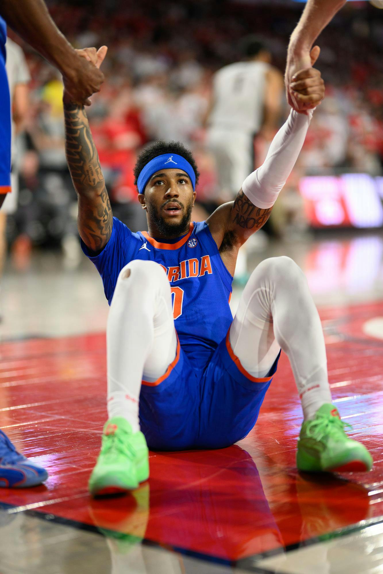 Florida guard Boogie Fland (0) is helped up by teammates during the first half of an NCAA college basketball gme against Georgia, Wednesday, Feb. 11, 2026, in Athens, Ga.