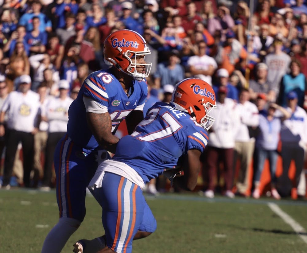Florida’s Anthony Richardson pictured handing the ball to running back Dameon Pierce during the Gators’ Nov. 27 game against Florida State.