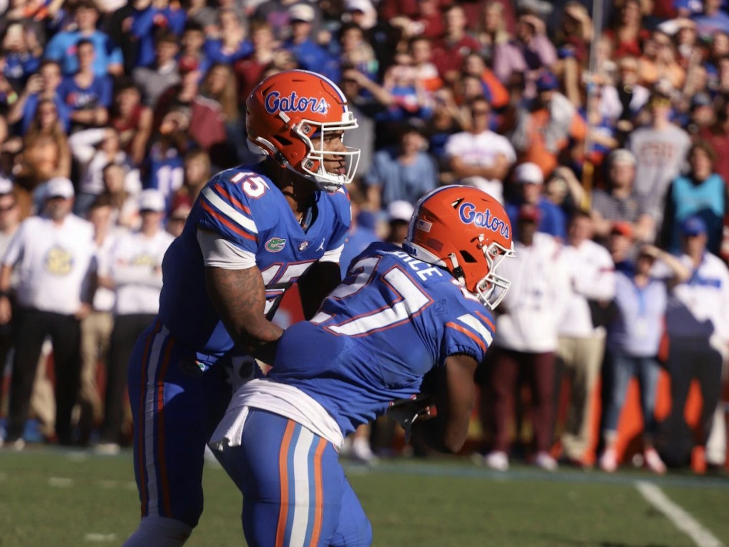 Florida’s Anthony Richardson pictured handing the ball to running back Dameon Pierce during the Gators’ Nov. 27 game against Florida State.