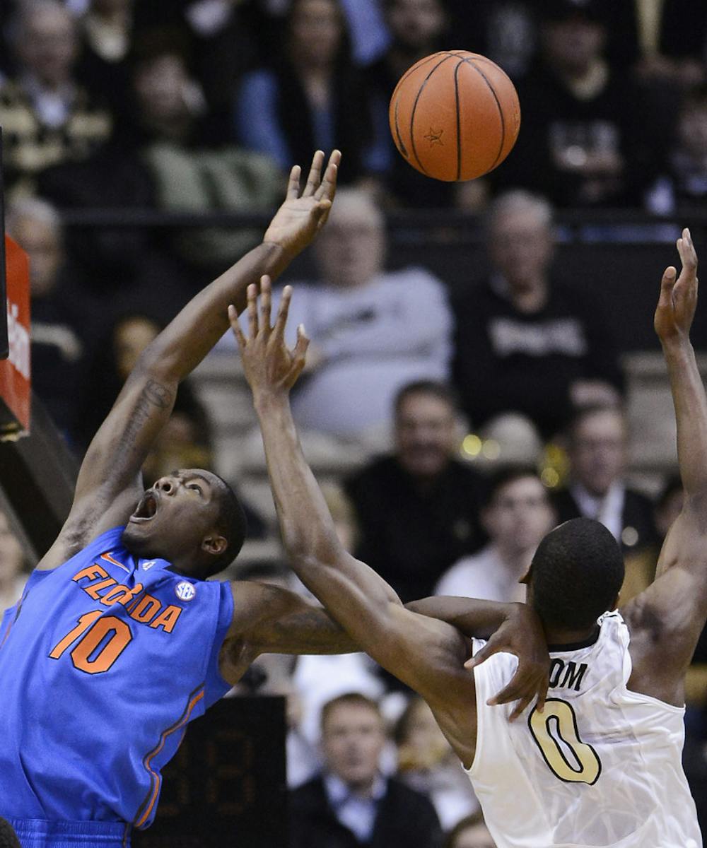 <p>Dorian Finney-Smith (10) is fouled by Vanderbilt forward Rod Odom (0) during the Gators’ 57-54 win against the Commodores on Tuesday in Nashville, Tenn.</p>