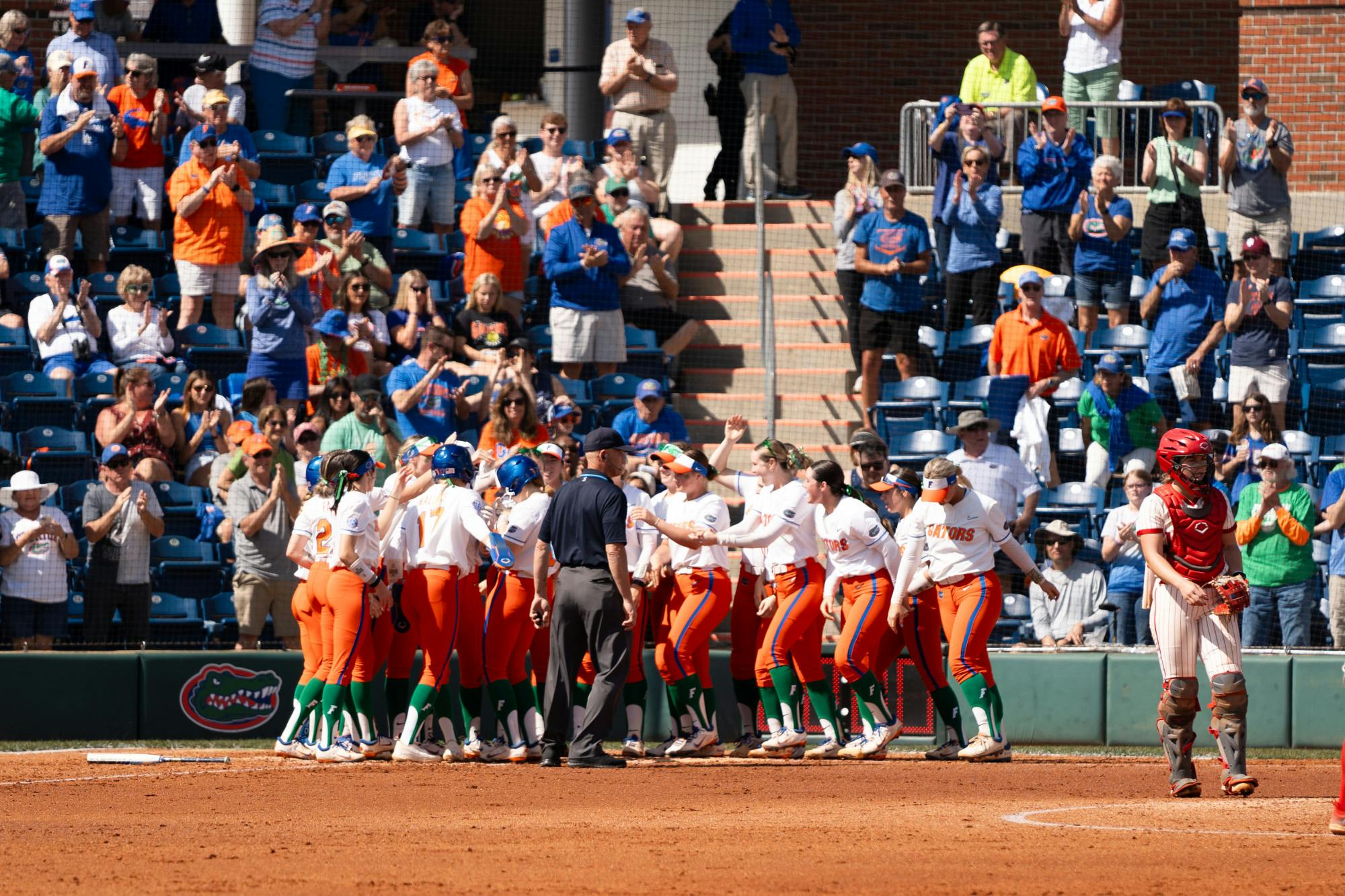 The Florida softball team celebrates a home run in the team's game against Indiana University on Sunday, March 17, 2024. 