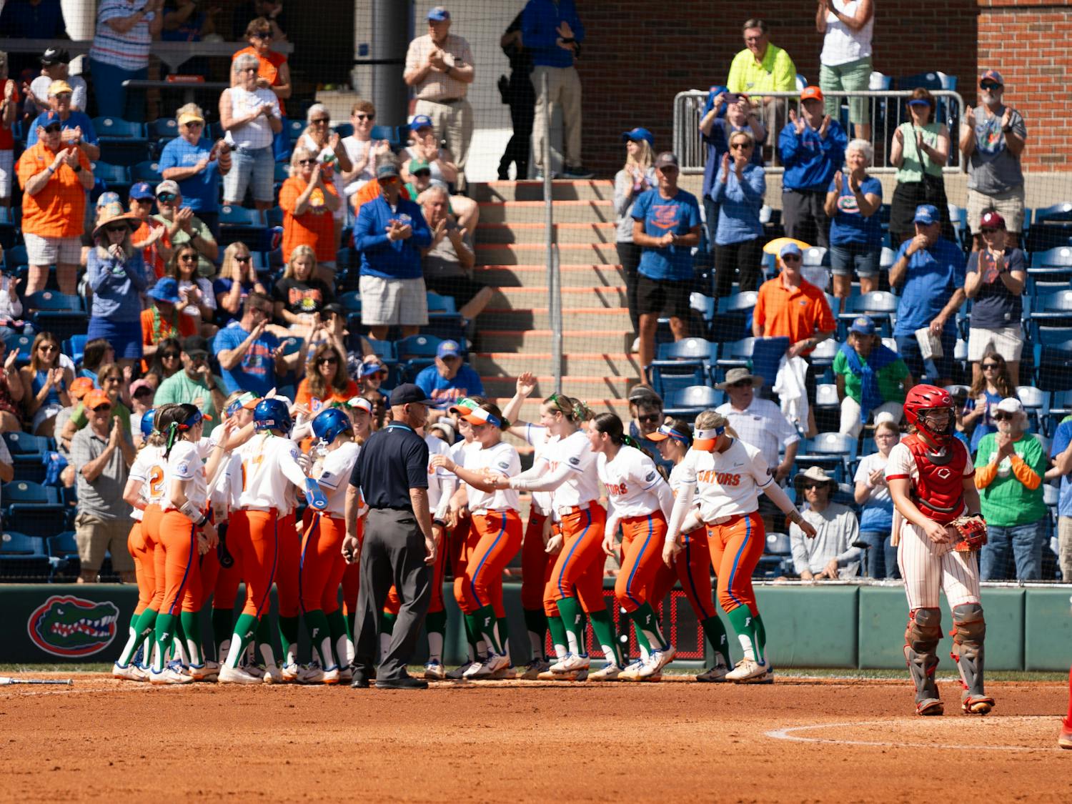 The Florida softball team celebrates a home run in the team's game against Indiana University on Sunday, March 17, 2024. 
