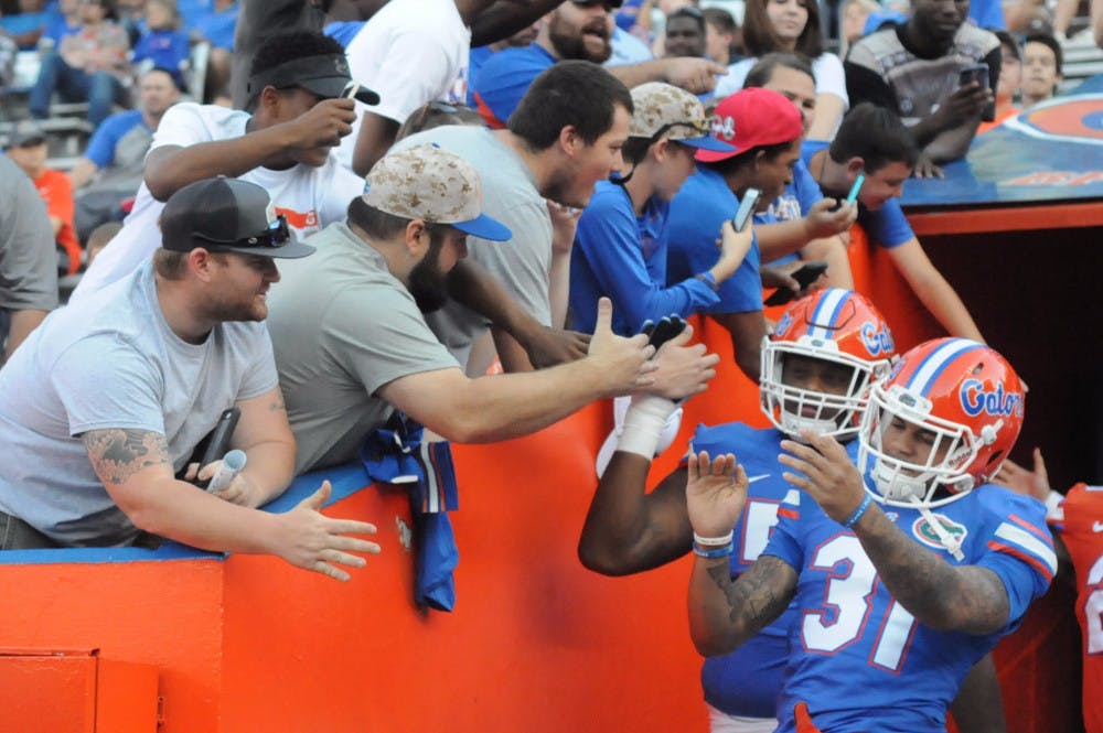 Cornerback Jalen Tabor high fives fans while walking out of the tunnel prior to the Orange &amp; Blue Debut on April 8, 2016, at Ben Hill Griffin Stadium.
