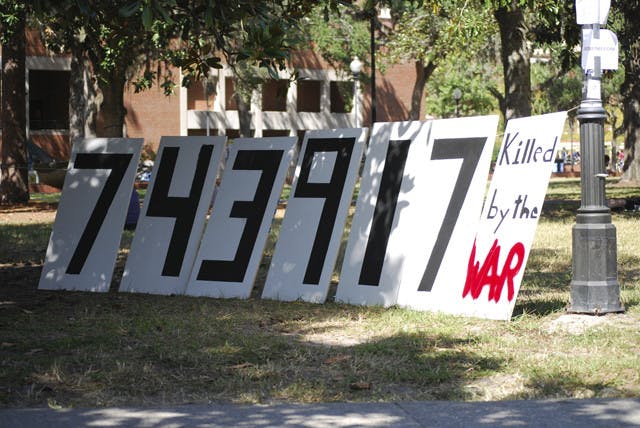 A sign that reads "743,917 killed by the war" sits on the Plaza of the Americas at a protest on Friday against the wars in Afghanistan and Iraq.