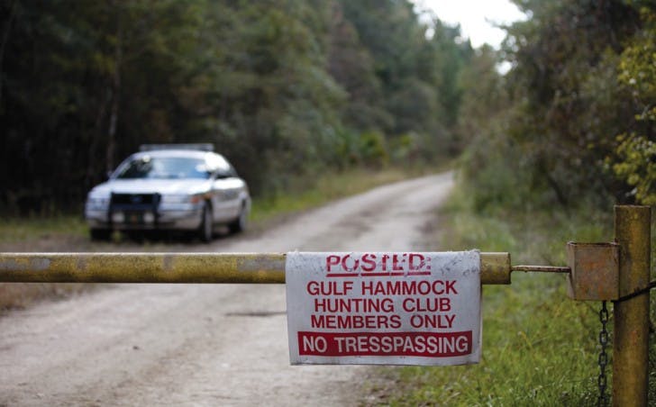 A Levy County Sheriff’s Office car blocks the road leading to the Gulf Hammock Hunting Club on Friday afternoon where the confirmed remains of missing UF student Christian Aguilar were discovered.