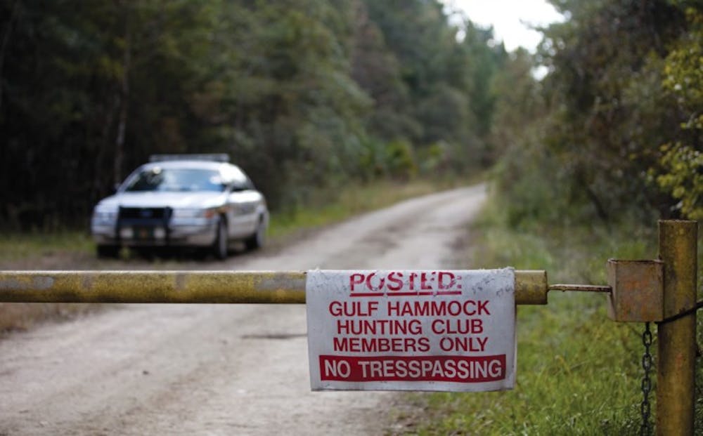 <p>A Levy County Sheriff’s Office car blocks the road leading to the Gulf Hammock Hunting Club on Friday afternoon where the confirmed remains of missing UF student Christian Aguilar were discovered.</p>