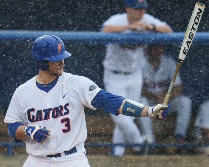 Mike Zunino bats in the seventh inning just before the first rain delay against N.C. State on Saturday. Zunino completed the at-bat with a home run two hours and three minutes later.&nbsp;