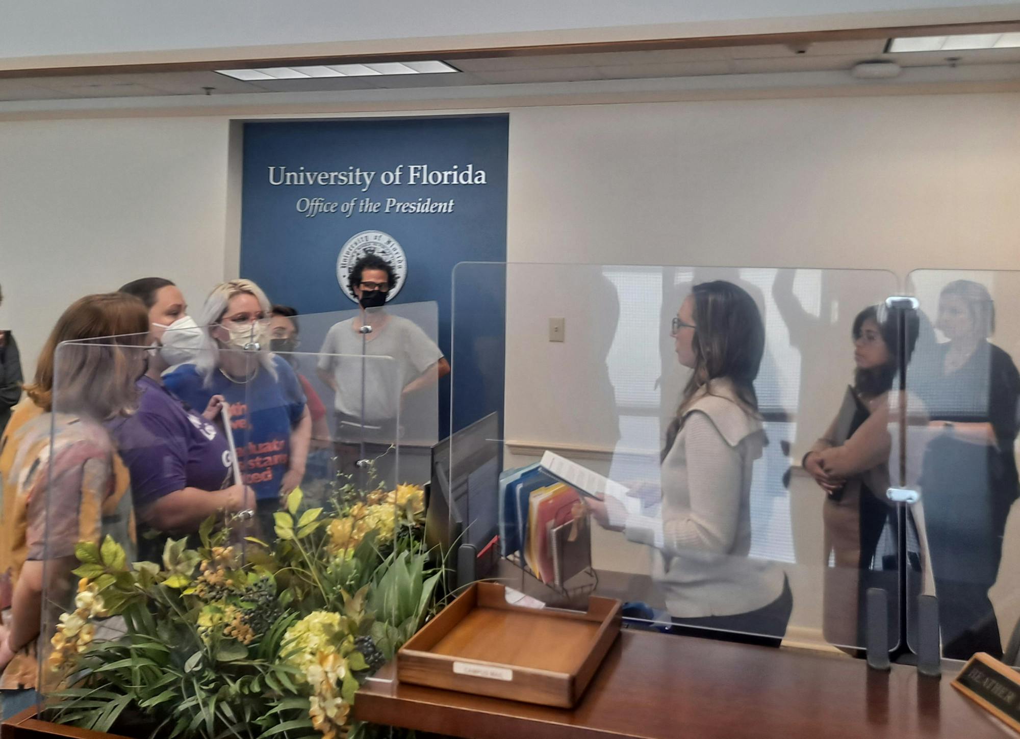 GAU officers Eva Garcia-Ferres, Rachel Hartnett and Bryn Taylor present GAU research to President Kent Fuchs' secretary.