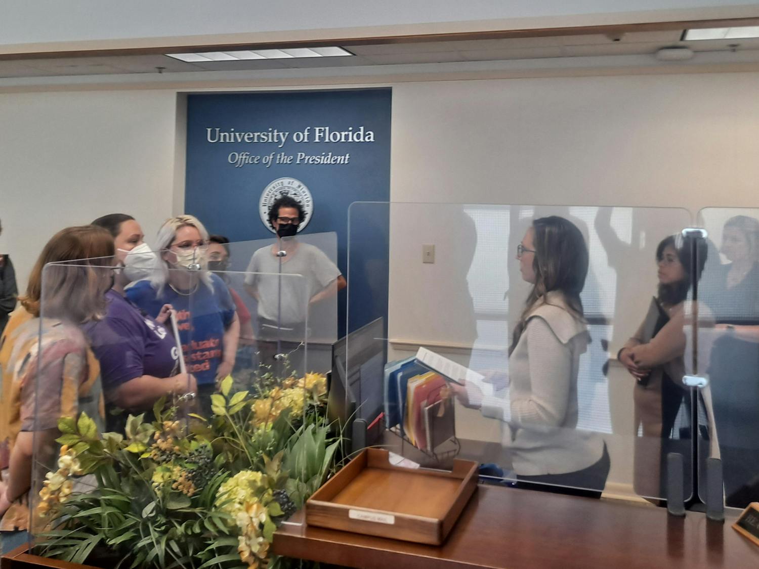 GAU officers Eva Garcia-Ferres, Rachel Hartnett and Bryn Taylor present GAU research to President Kent Fuchs' secretary.