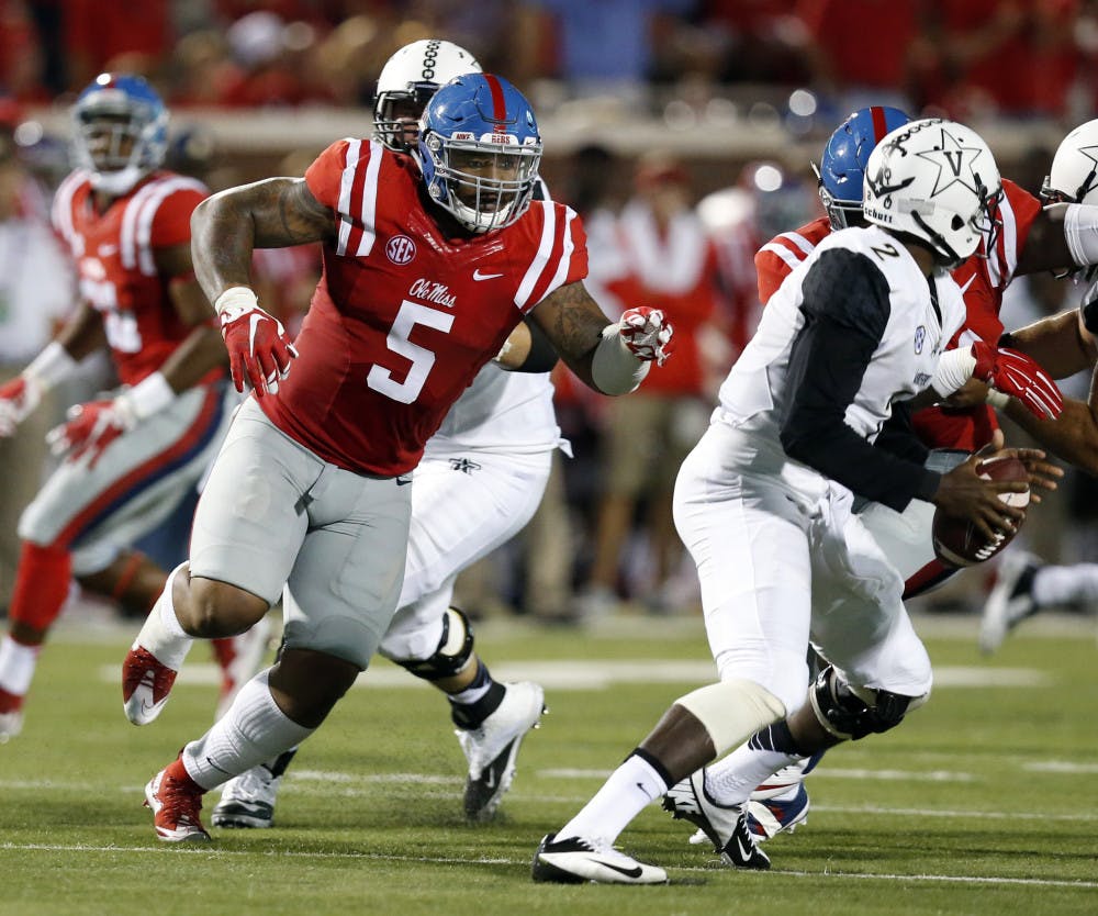 Mississippi defensive tackle Robert Nkemdiche (5) pursues Vanderbilt quarterback Johnny McCrary (2) during the first half of an NCAA college football game Saturday, Sept. 26, 2015, in Oxford, Miss.