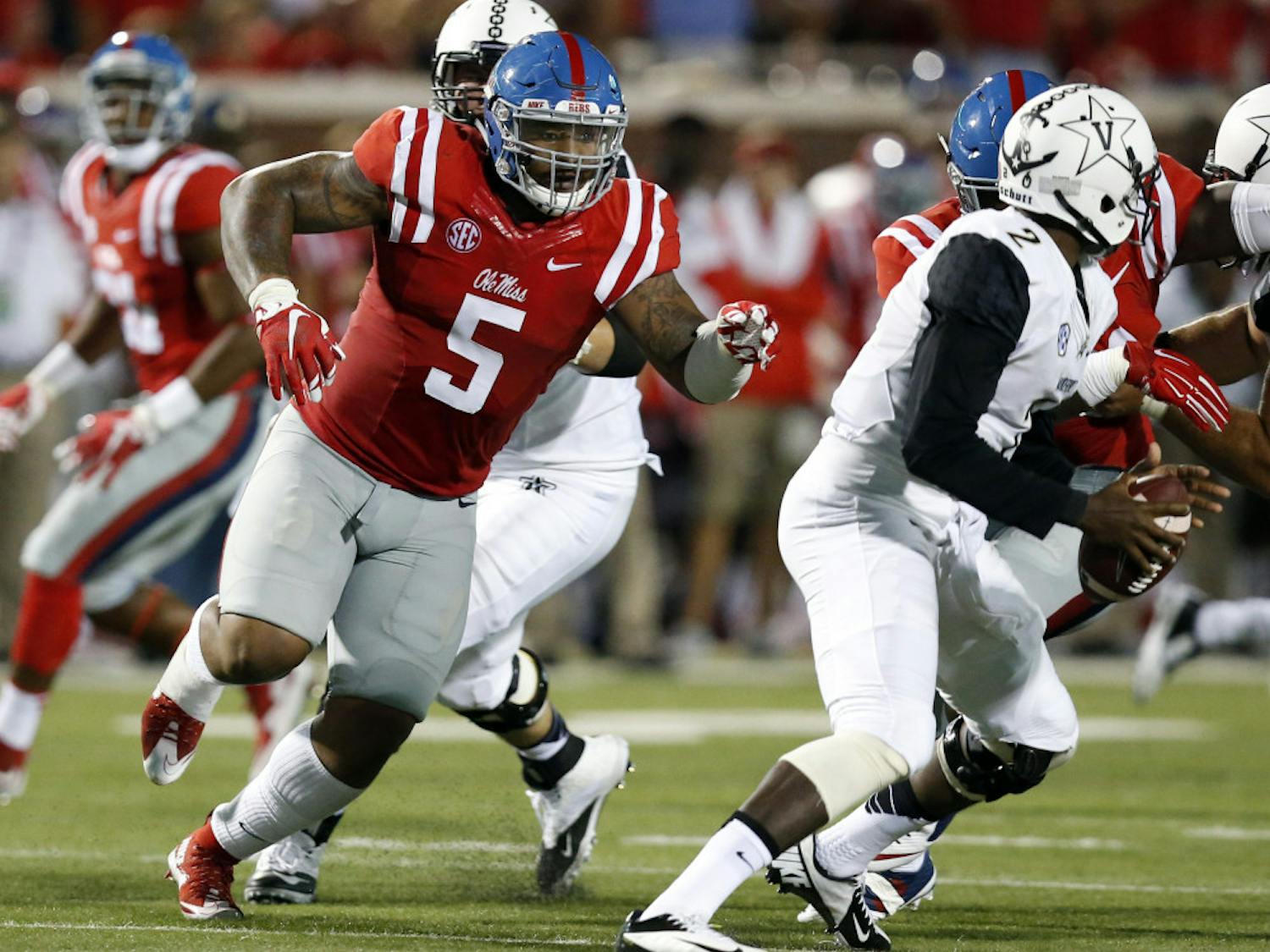 Mississippi defensive tackle Robert Nkemdiche (5) pursues Vanderbilt quarterback Johnny McCrary (2) during the first half of an NCAA college football game Saturday, Sept. 26, 2015, in Oxford, Miss.