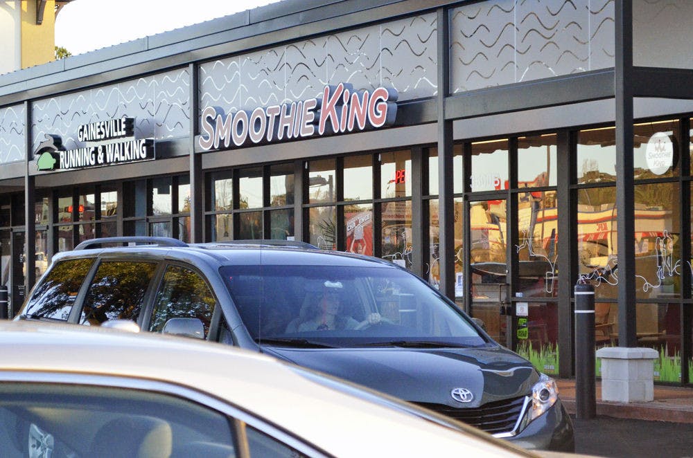 Cars drive past Smoothie King, located at 3600 SW Archer Road in Butler Plaza, on Monday.