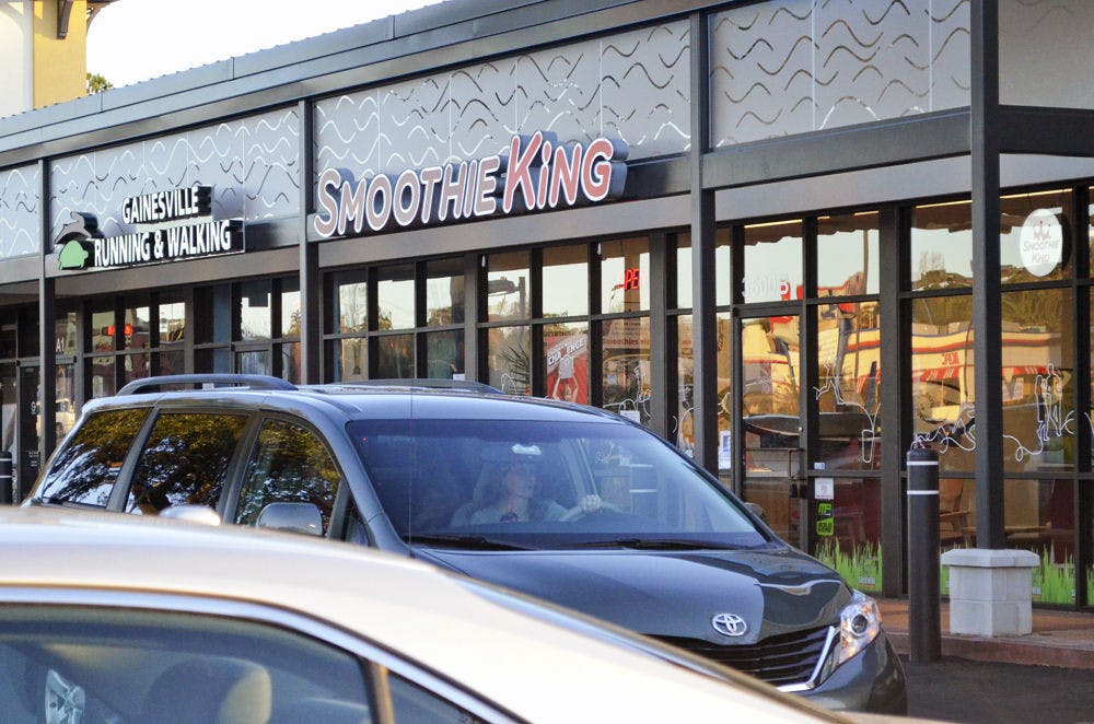<p>Cars drive past Smoothie King, located at 3600 SW Archer Road in Butler Plaza, on Monday.</p>