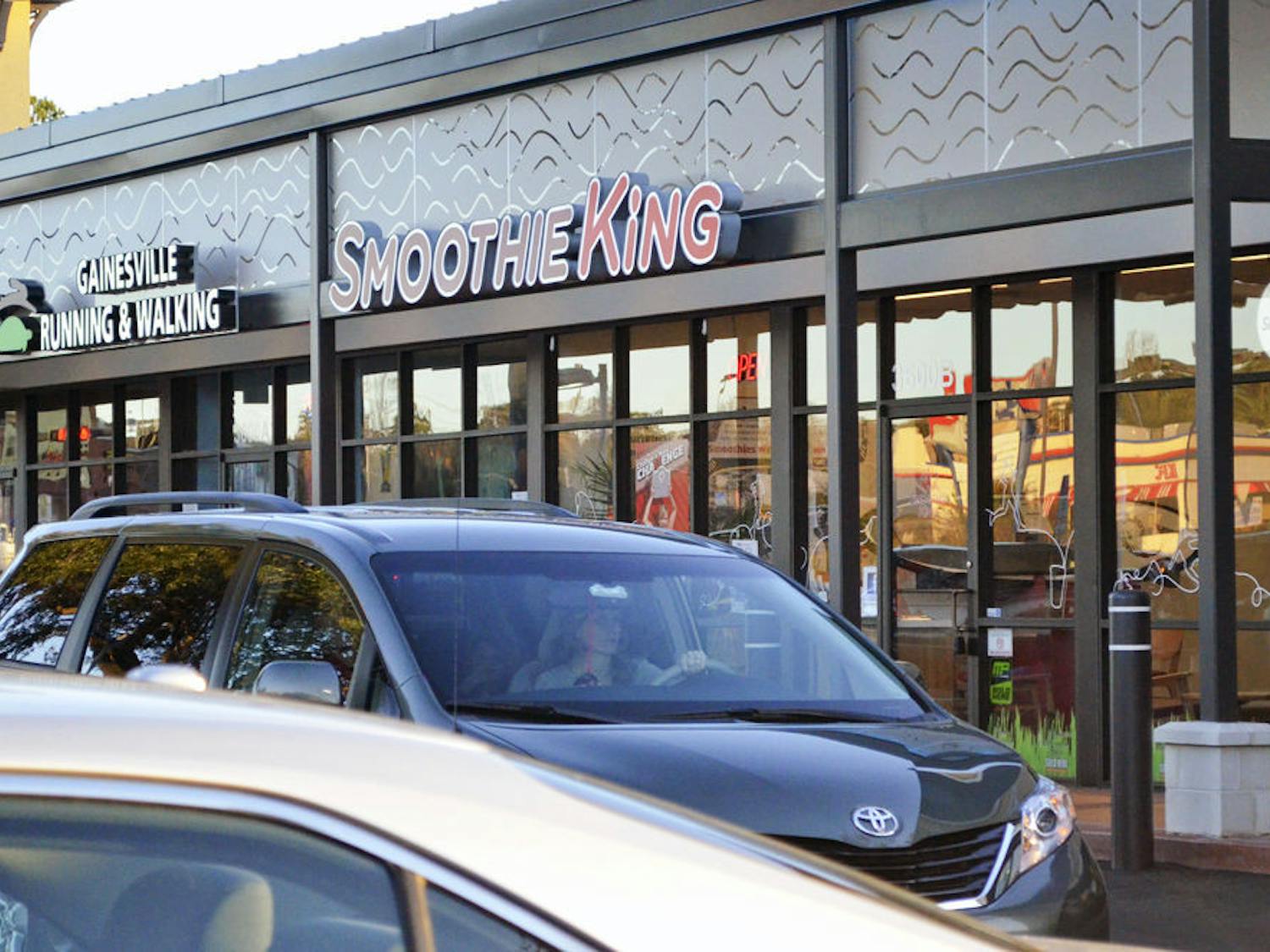 Cars drive past Smoothie King, located at 3600 SW Archer Road in Butler Plaza, on Monday.