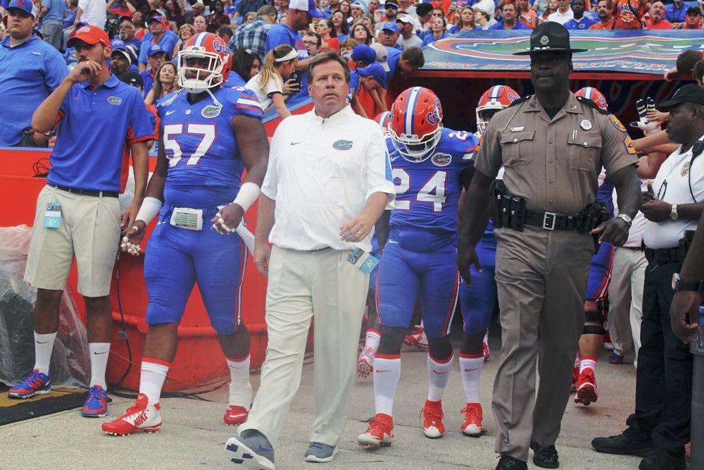 UF football coach Jim McElwain walks out of the tunnel Florida's 61-13 win against New Mexico State on Saturday at Ben Hill Griffin Stadium.