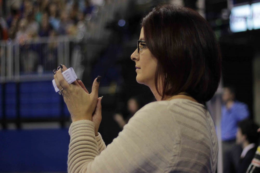 <p>UF coach Jenny Rowland applauds her gymnasts during Florida’s win against Alabama on Jan. 29, 2016, in the O’Connell Center.</p>