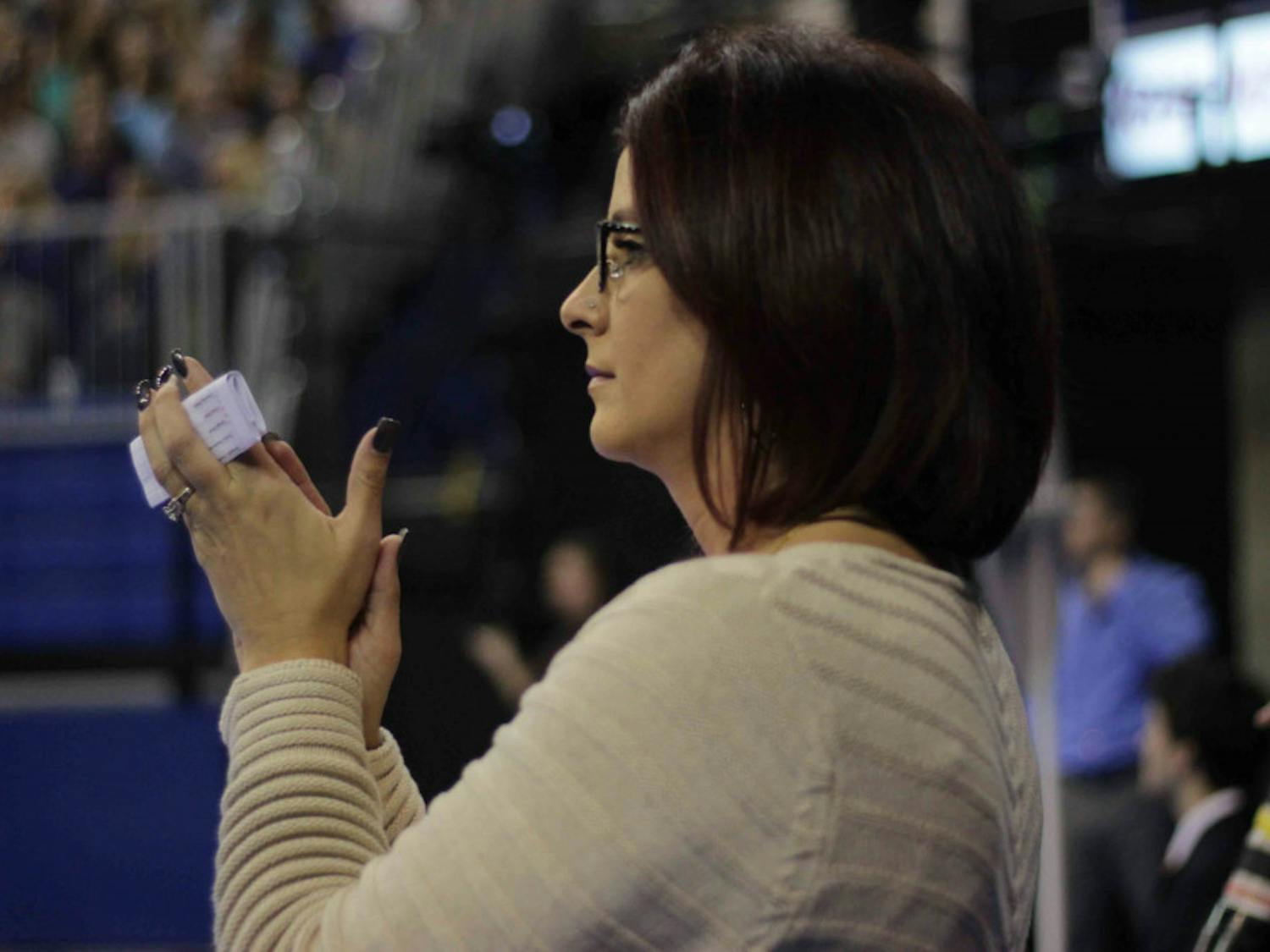 UF coach Jenny Rowland applauds her gymnasts during Florida’s win against Alabama on Jan. 29, 2016, in the O’Connell Center.