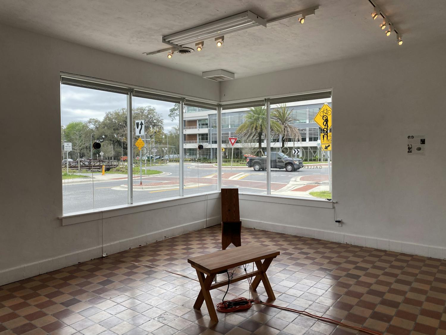 Handmade furniture from salvaged old-growth pine wood stands in the center of the “We Live Inside” exhibition at 4Most Gallery.