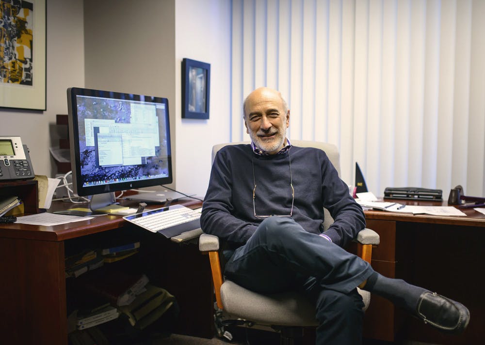 <p>Professor Jose C. Principe poses in his office in the New Engineering Building Wednesday afternoon. Principe was awarded the UF Teacher/Scholar of the Year for 2014-2015.</p>