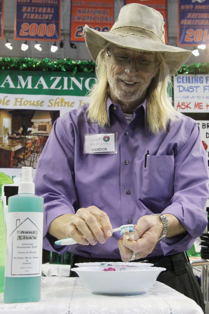 Darrell "Chi" Chichester, 58, shines his wedding ring with Aunt Lisa's Amazing Stuff at the 2015 Craft Festival. The "shine in a bottle" says it also cleans ceiling fans and stainless steel.