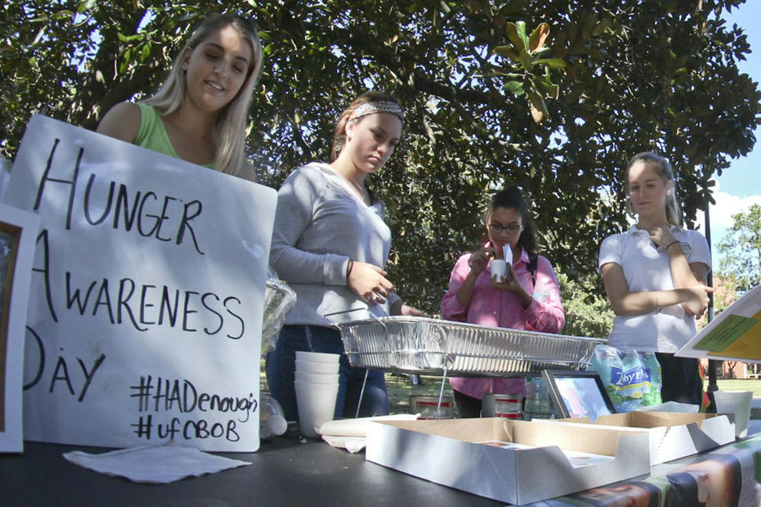 To raise awareness of the 793 million undernourished people around the world, UF Children Beyond Our Borders members, from left, Madeline Bieda, Gabriela Garcia, Manuela Gutierrez and Alexa Moore challenge students Nov. 16, 2015, on Plaza of the Americas to go a day with only a cup of rice and water. “The power of education breaks the cycle of social injustice,” said Bieda, a 21-year-old psychology senior.