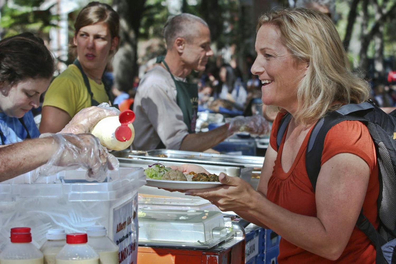 Lisa Athearn, 42-year-old UF public speaking professor, gets krishna food at the Plaza of the Americas on Nov. 16, 2015. "I ate krishna when I was a student here 13 years ago," she said. "It's the best $3.50 spent."