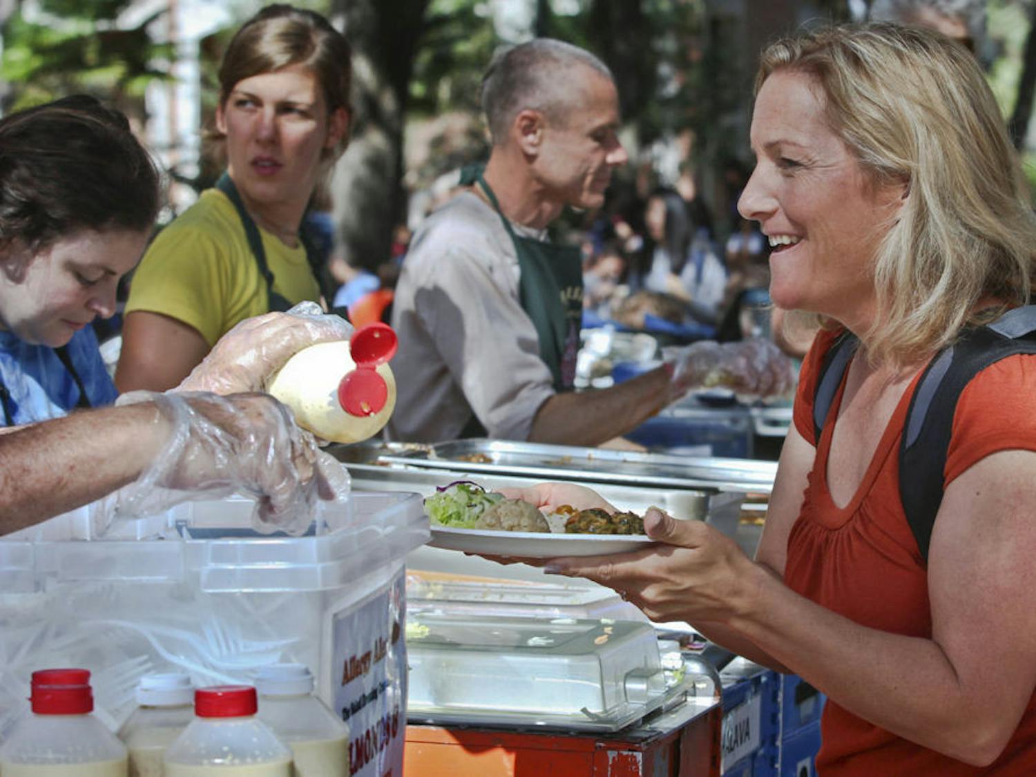 Lisa Athearn, 42-year-old UF public speaking professor, gets krishna food at the Plaza of the Americas on Nov. 16, 2015. "I ate krishna when I was a student here 13 years ago," she said. "It's the best $3.50 spent."