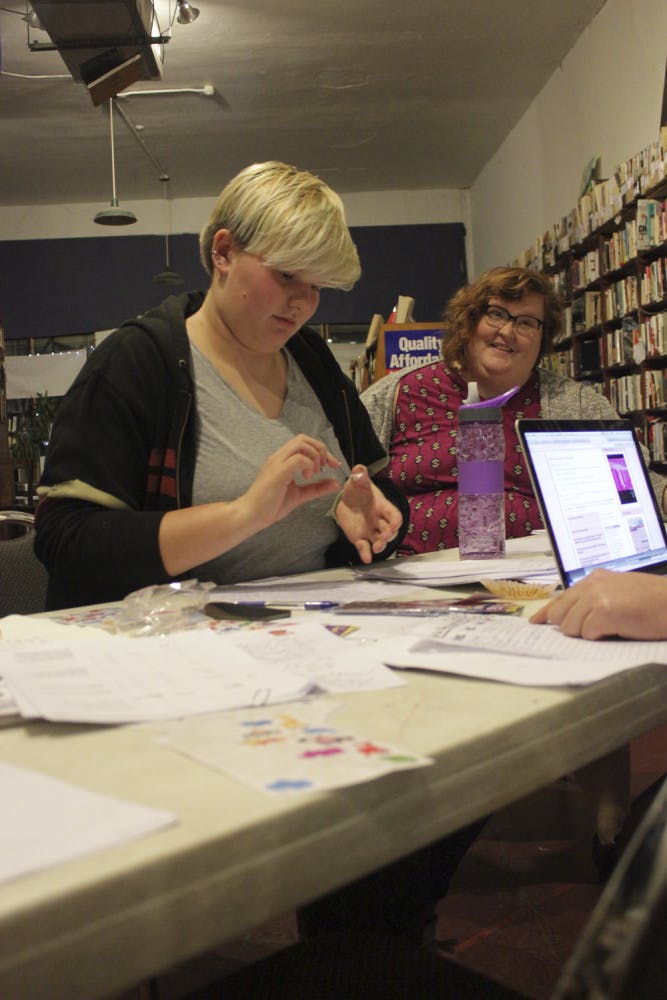 Iso Jones, left, a 22-year-old UF zoology freshman, and Emily Sparr, a 32-year-old software developer liaison and Gainesville resident, participate in Trans Prisoner Day of Action at the Civic Media Center on Friday. Jones wrote a letter to a transwoman prisoner in Ohio offering someone to talk to.