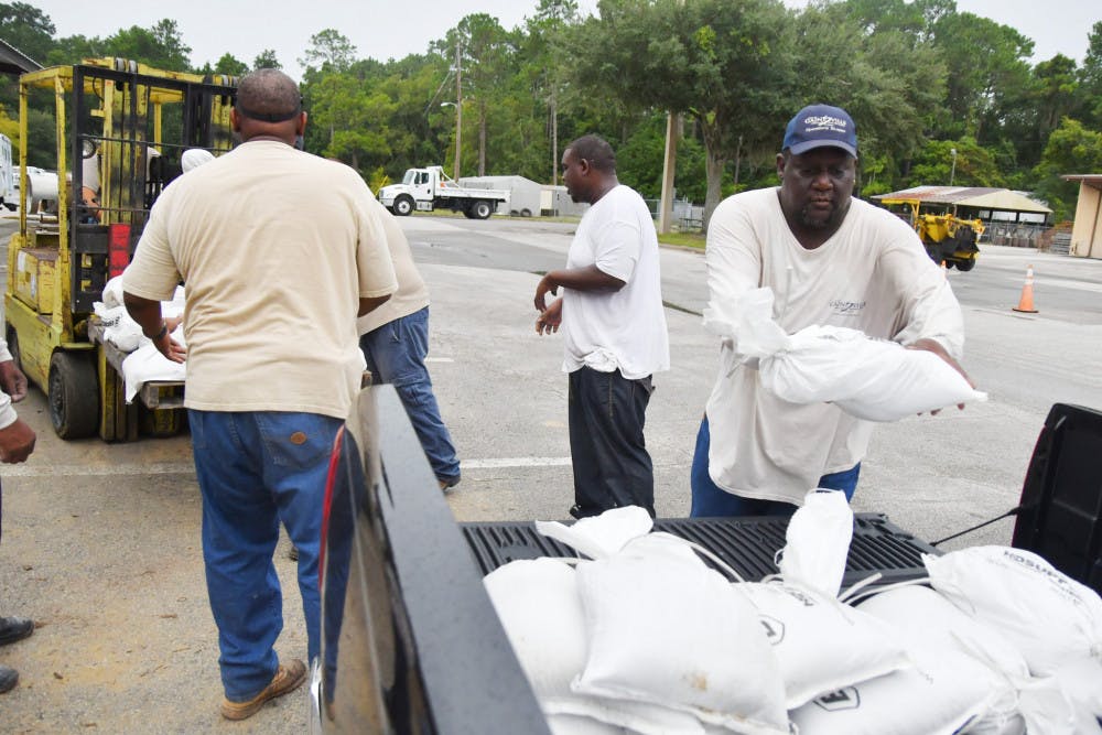 <p dir="ltr">Willie Young throws a sandbag into a truck at the City of Gainesville’s Public Works Department. The city provided up to 10 sandbags a car on Wednesday and Thursday to prepare for Hurricane Hermine.</p>