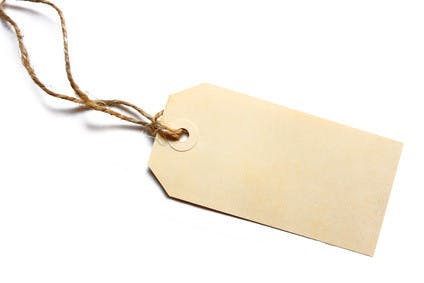 Blank tag tied with brown string. Price tag, gift tag, sale tag, address label, etc.