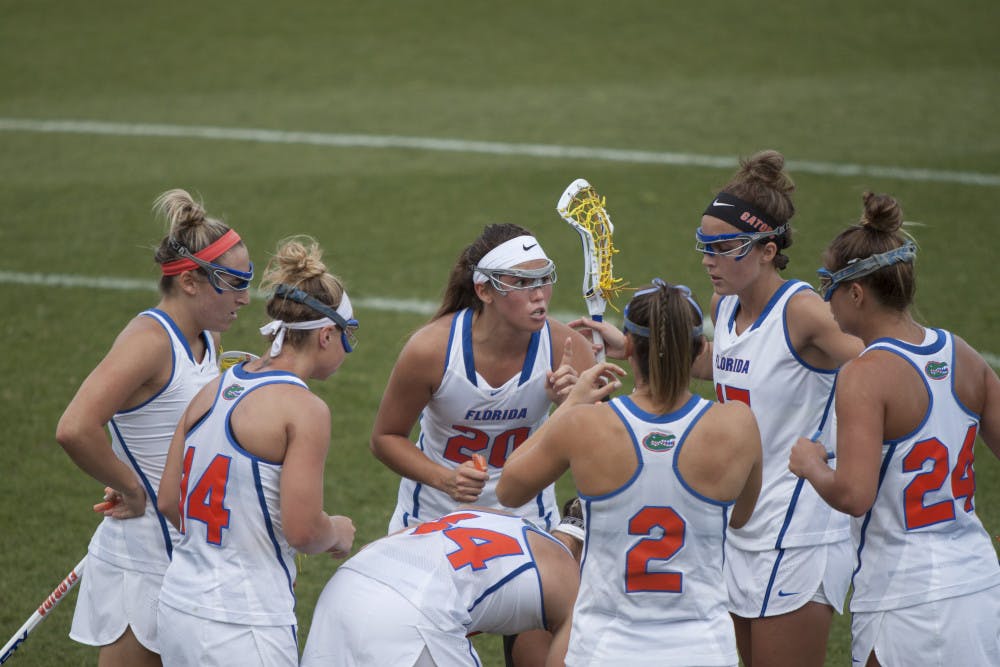 <p>Florida's lacrosse team huddles together during its 15-8 win against Denver on March 25, 2017, at Donald R. Dizney Stadium.</p>