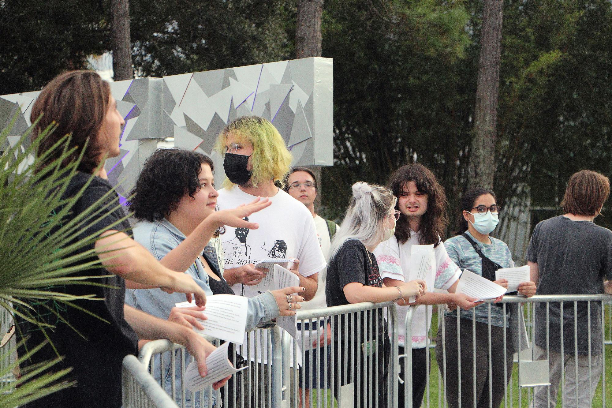 Members of the UF chapter of Young Democratic Socialists of America hand out leaflets to attendees of a private event at the Harn Museum Thursday, Oct. 13, 2022.