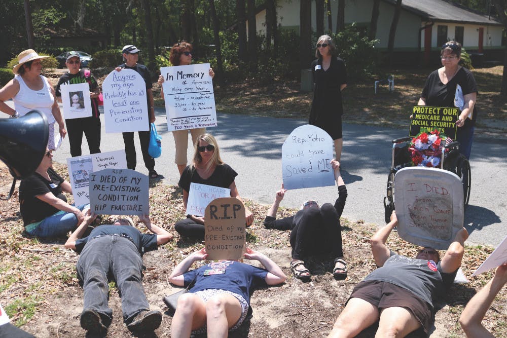 <p>As a way of protesting the American Health Care Act, a group of about 30 local activists staged a die-in at congressman Ted Yoho’s office in Gainesville Tuesday.</p>