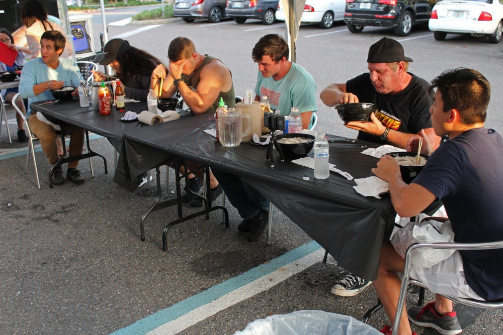 The contestants at the Taste Pho Eating Contest all sit doing their best Thursday evening. The first place prize for the competition was $300.
