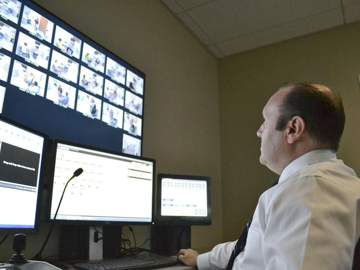 Dan Pollock, the head internet technician at the Anaclerio Learning and Assessment Center, gazes upon 18 screens streaming live footage of first year medical students interacting with volunteers acting as patients Aug. 28, 2015. Pollock’s voice, jokingly called the voice of “God,” can be heard in the halls of the center instructing students during their lesson.