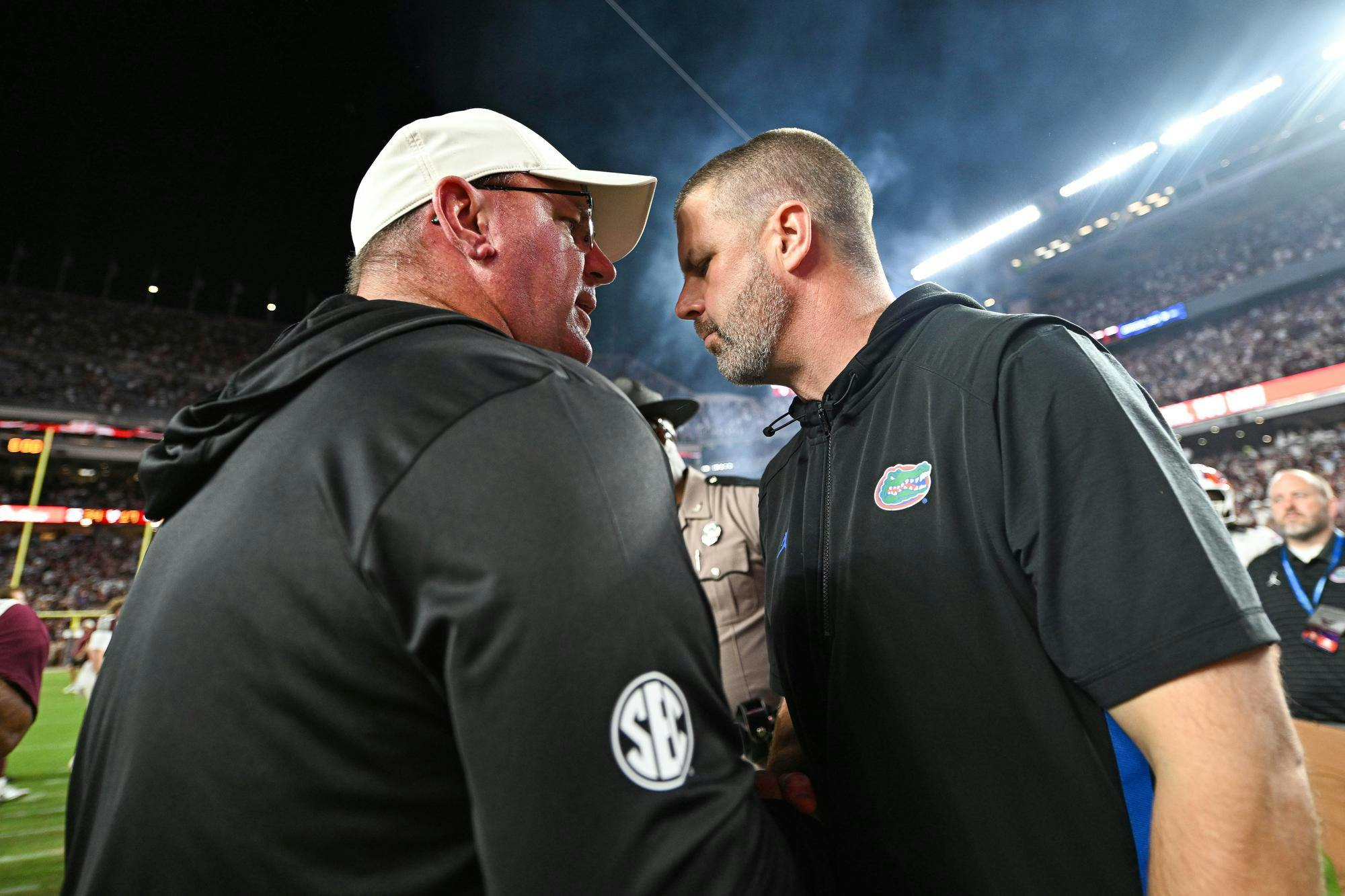 Texas A&M Aggies head coach Mike Elko and Florida Gators head coach Billy Napier meet at midfield after a NCAA college football game, Saturday, Oct. 11, 2025, in College Station, Texas.