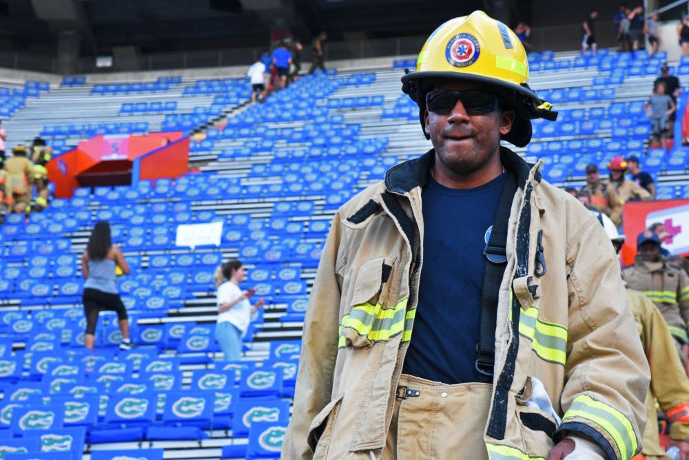 Karem Scott-Kotb, 33, walks down the steps of Ben Hill Griffin Stadium Wednesday as part of the 9/11 Memorial Stair Climb hosted by The Grit Foundation, UF Student Government and UF Collegiate Veterans Society. Participants climbed 1,980 steps, equivalent to the number of stairs in one of the World Trade Center buildings. About 300 people attended the event, which raised money for The Grit Foundation to buy equipment for local first responders.