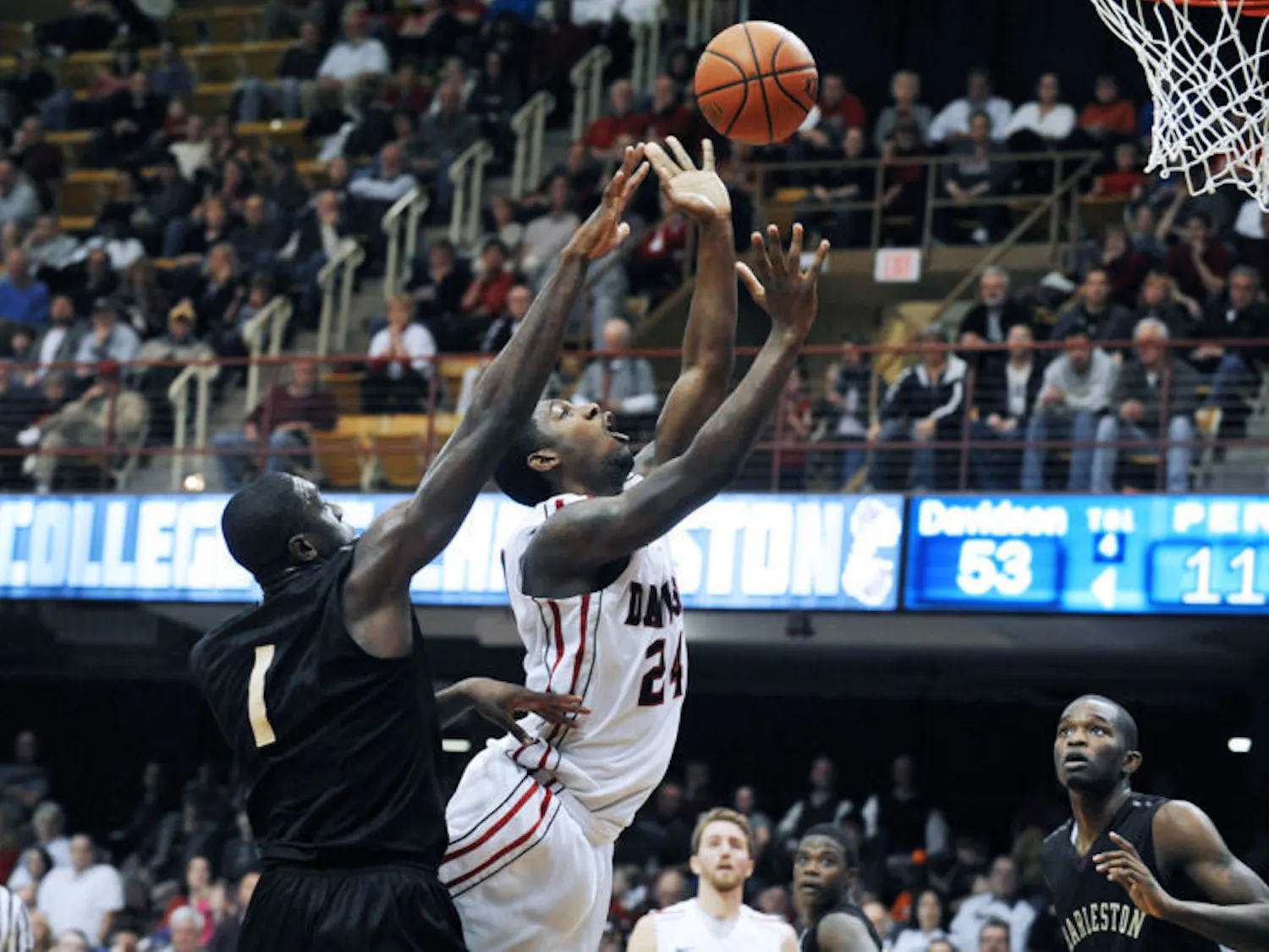 Davidson’s De’Mon Brooks (24) shoots as College of Charleston’s Adjehi Baru (1) defends during the second half of the Southern Conference tournament final on March 11.