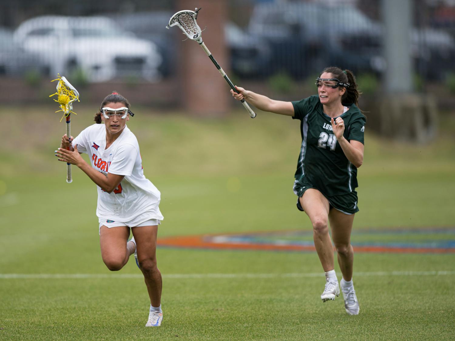 Florida Gators defender Celeste Forte (20) runs with the ball in a lacrosse game against Loyola Maryland in Gainesville, Fla., on Saturday, March 8, 2025.