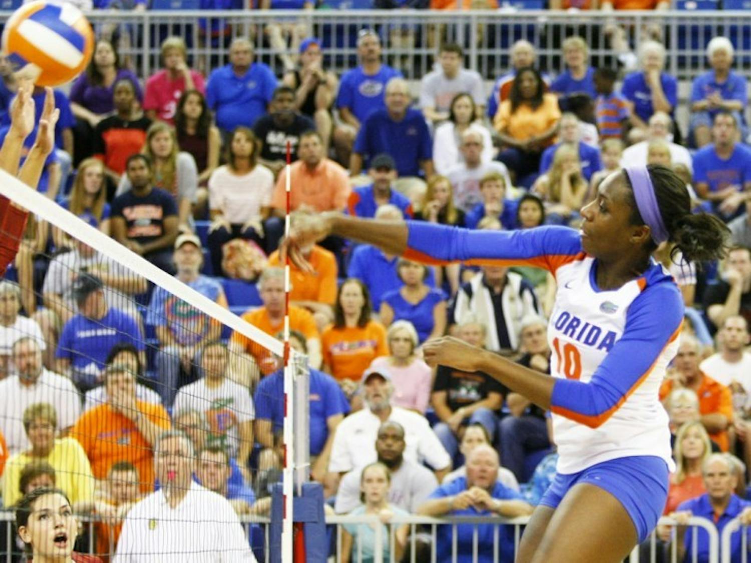 Junior middle blocker Chloe Mann hits the ball over the net in Florida’s 3-0 win against Arkansas on Oct. 5, 2012, in the O’Connell Center.&nbsp;