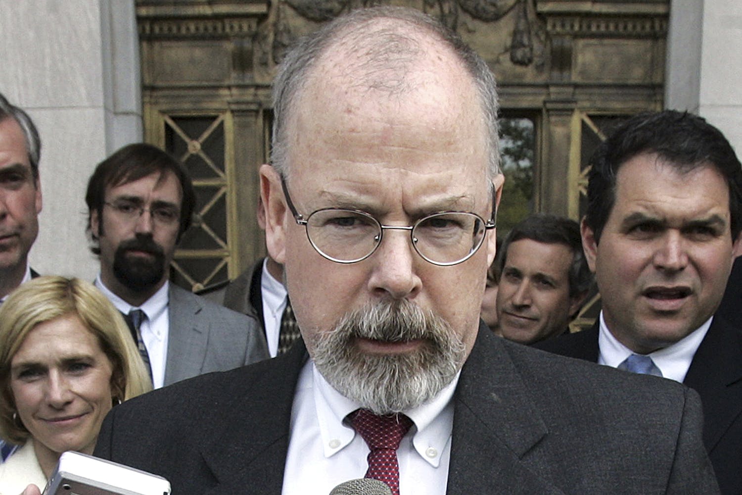 FILE - In this April 25, 2006, file photo, John Durham speaks to reporters on the steps of U.S. District Court in New Haven, Conn. Durham, Connecticut’s U.S. attorney, is leading the investigation into the origins of the Russia probe. He is no stranger to high-profile, highly scrutinized investigations. (AP Photo/Bob Child, File)