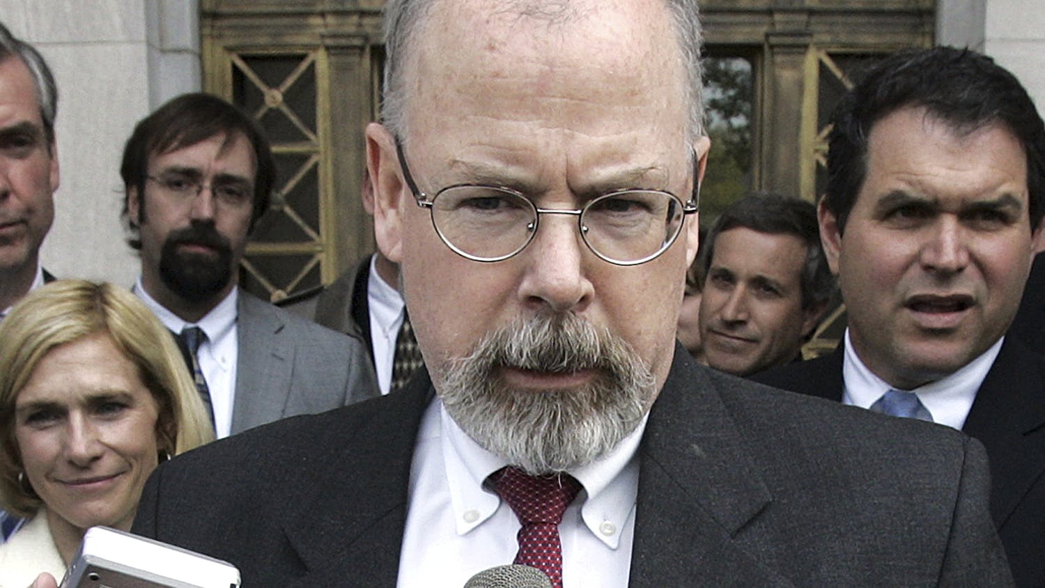 FILE - In this April 25, 2006, file photo, John Durham speaks to reporters on the steps of U.S. District Court in New Haven, Conn. Durham, Connecticut’s U.S. attorney, is leading the investigation into the origins of the Russia probe. He is no stranger to high-profile, highly scrutinized investigations. (AP Photo/Bob Child, File)