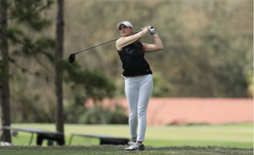 <p>Maisie Filler watches her drive in February at the Gators Invitational</p>