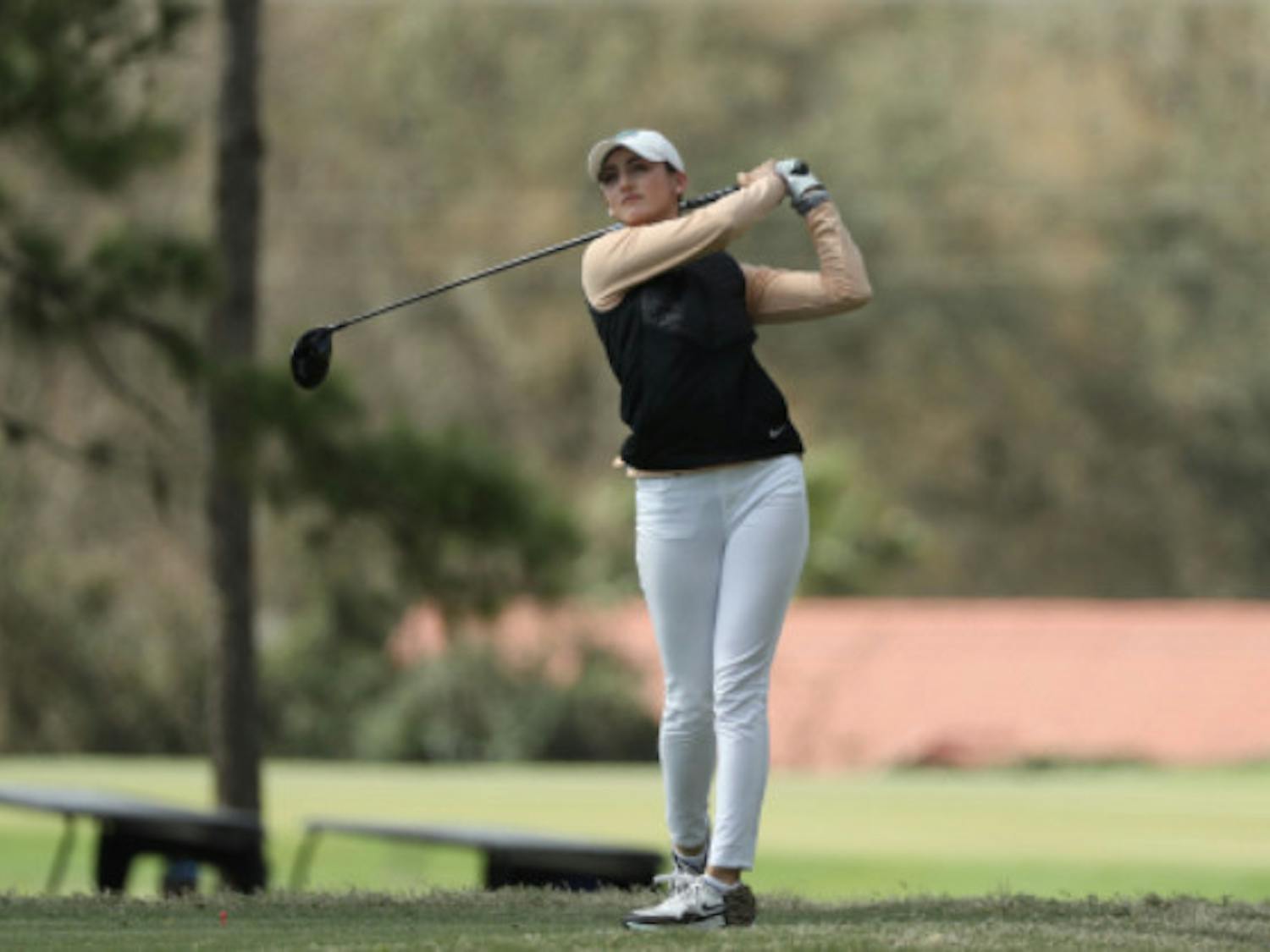 Maisie Filler watches her drive in February at the Gators Invitational