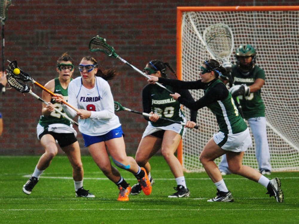 <p>Shannon Gilroy breaks away from a group of defenders during Florida’s 21-5 win against Jacksonville on Feb. 12 at Donald R. Dizney Stadium.</p>