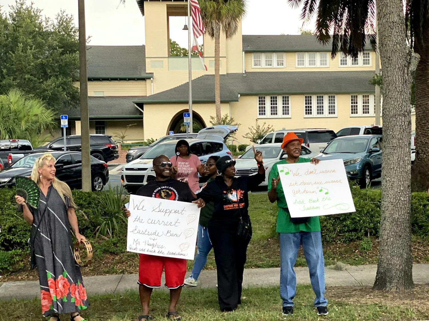 Demonstrators hold signs outside of Alachua County Public Schools Administration Building Tuesday, Aug. 16, 2022.